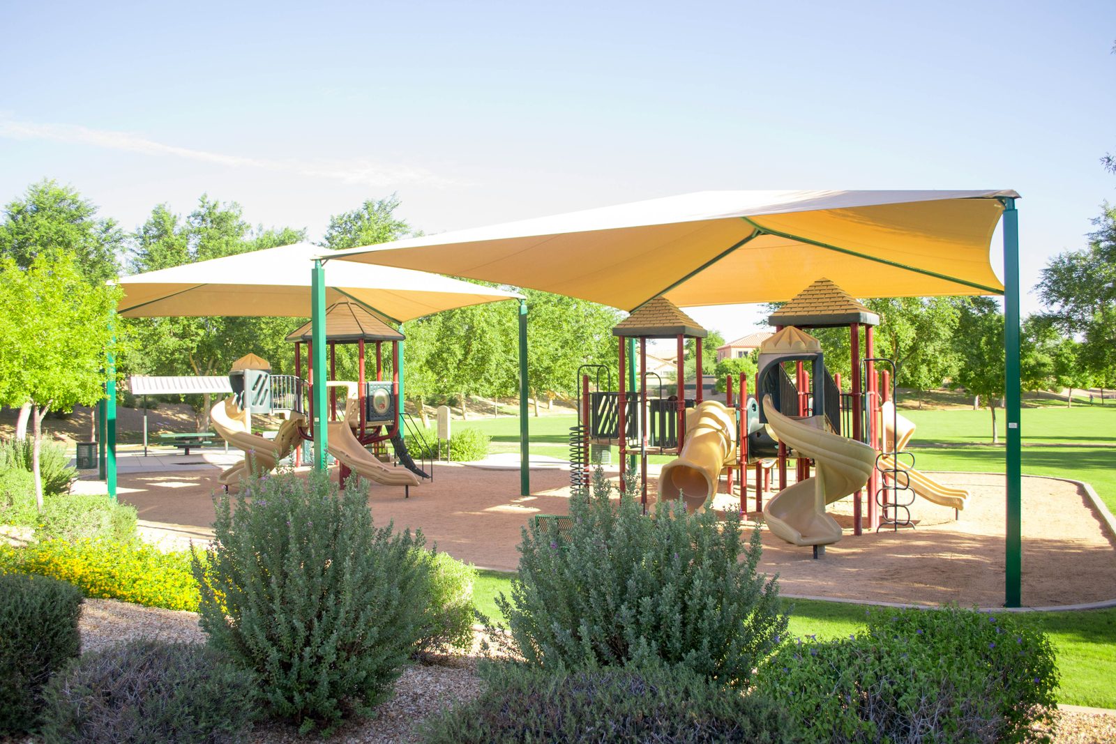 Shaded playground, paths and landscaped green space in Litchfield Manor, Surprise Arizona