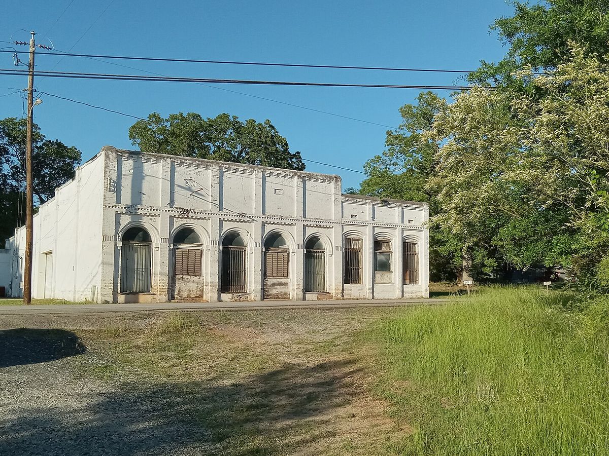 A historic masonry building with arched openings on Old Highway 17 in Avalon, Georgia
