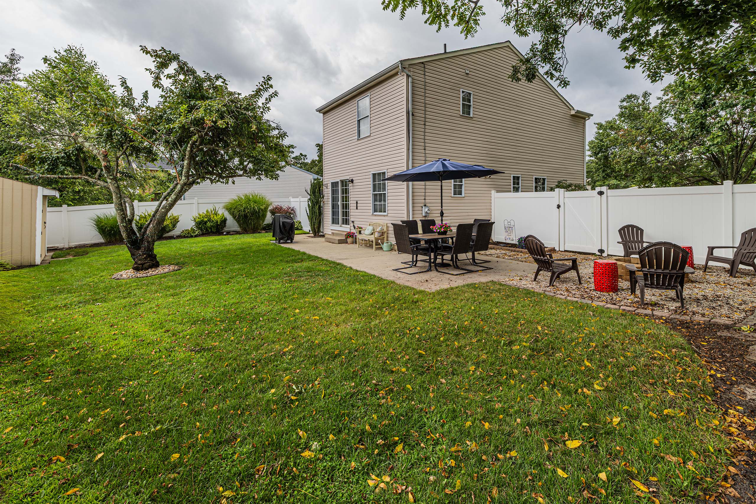146 Pine Avenue fenced backyard with fire pit