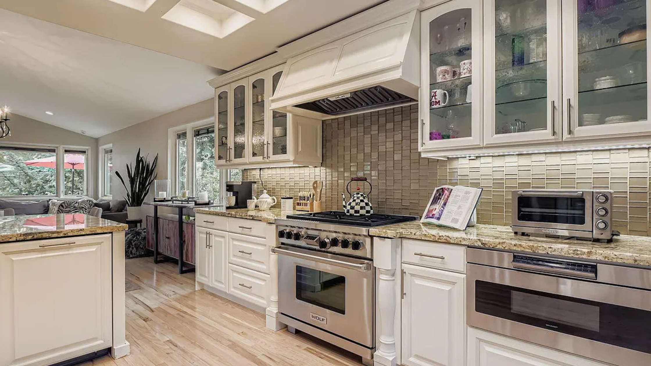 Chef&rsquo;s kitchen at 1921 Roffe Rd, Park City, with Wolf appliances, granite countertops, custom cabinetry, and hardwood floors in an open-concept layout.