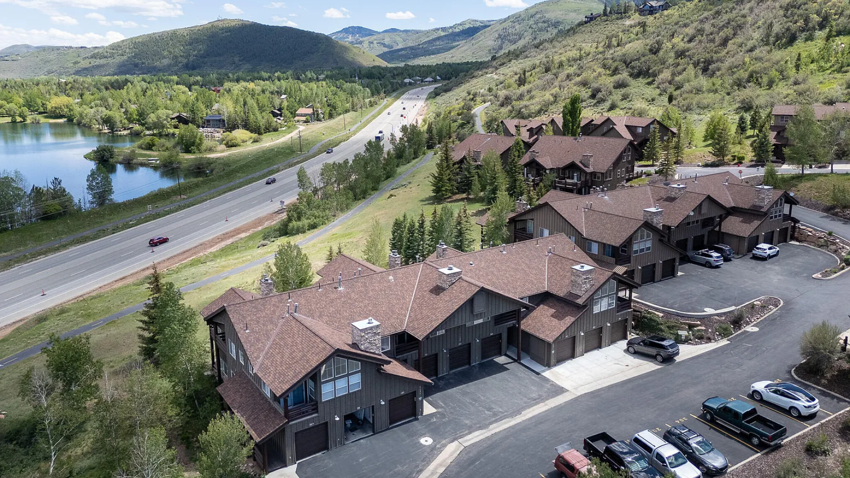Aerial view of 5135 Cove Canyon Dr Apt 204 in Park City's Sun Peak community featuring mountain views, lake views, and surrounding residential buildings.