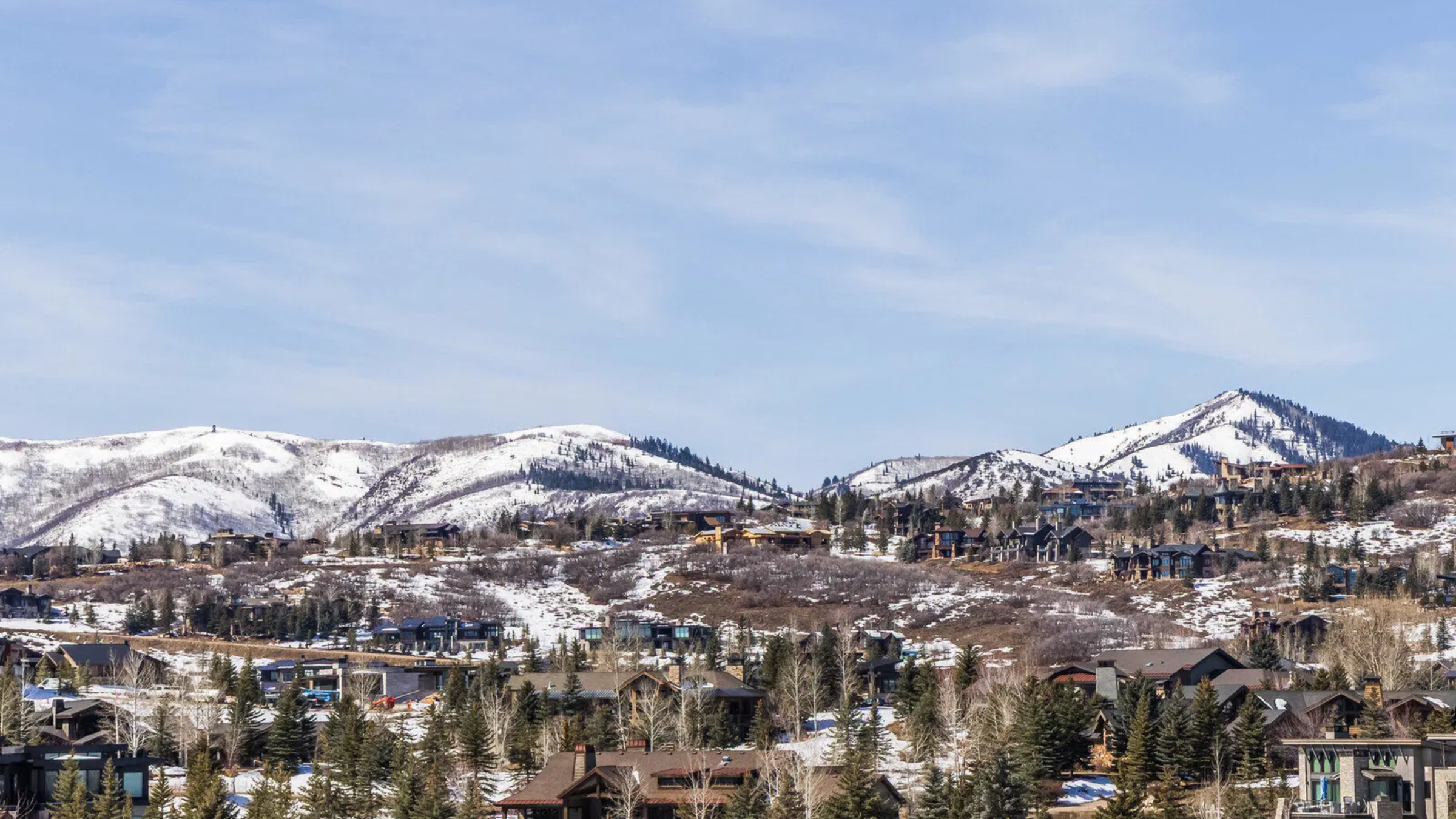 Luxury homes in Glenwild with snow-covered mountain views.