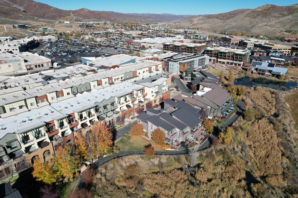 Aerial view of Kimball Junction in Park City, Utah, showcasing residential areas, commercial spaces, and surrounding mountains.