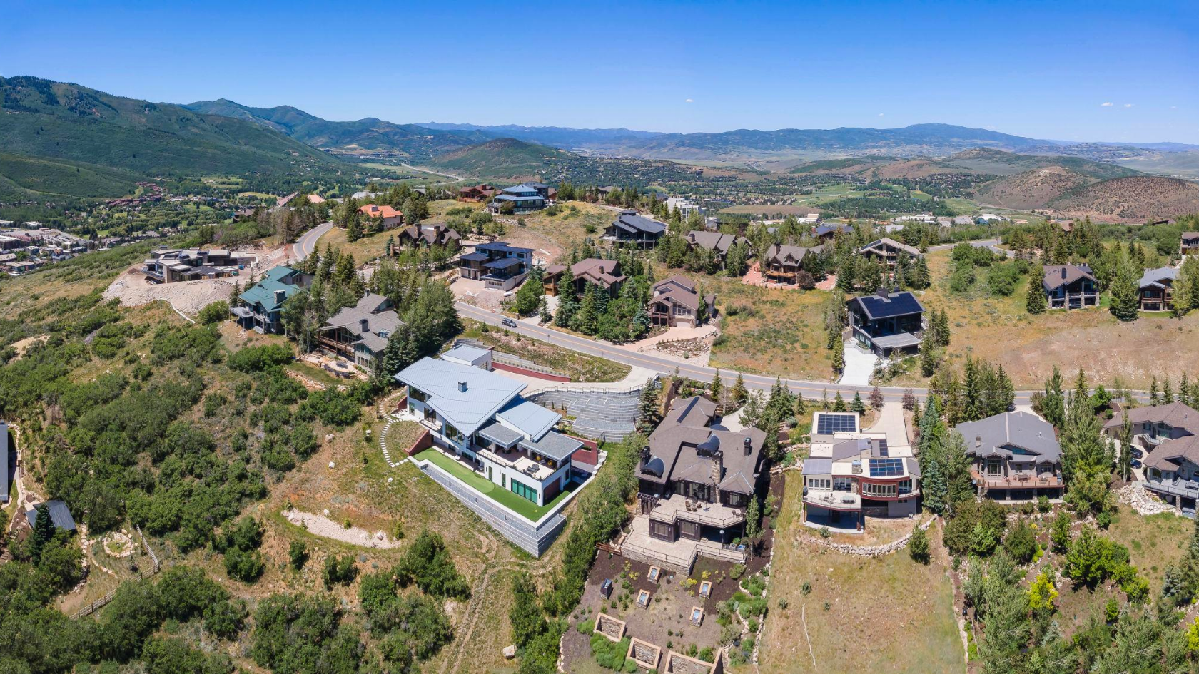 Aerial view of luxury neighborhoods in Park City showing residential homes, mountain terrain, and long-term real estate investment areas