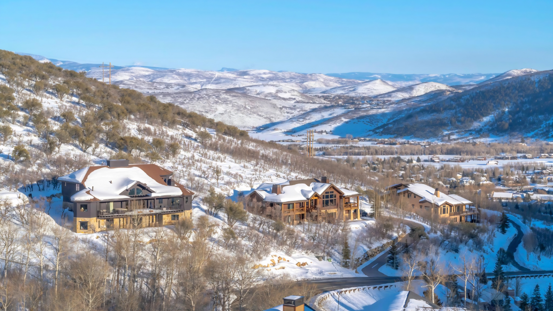Luxury homes in Park City during winter with snowy mountain views and residential hillside neighborhood