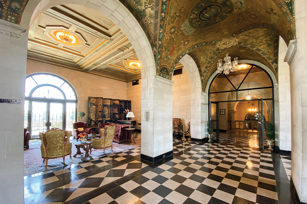 View of the ornate hall and arches inside of the Marland Mansion
