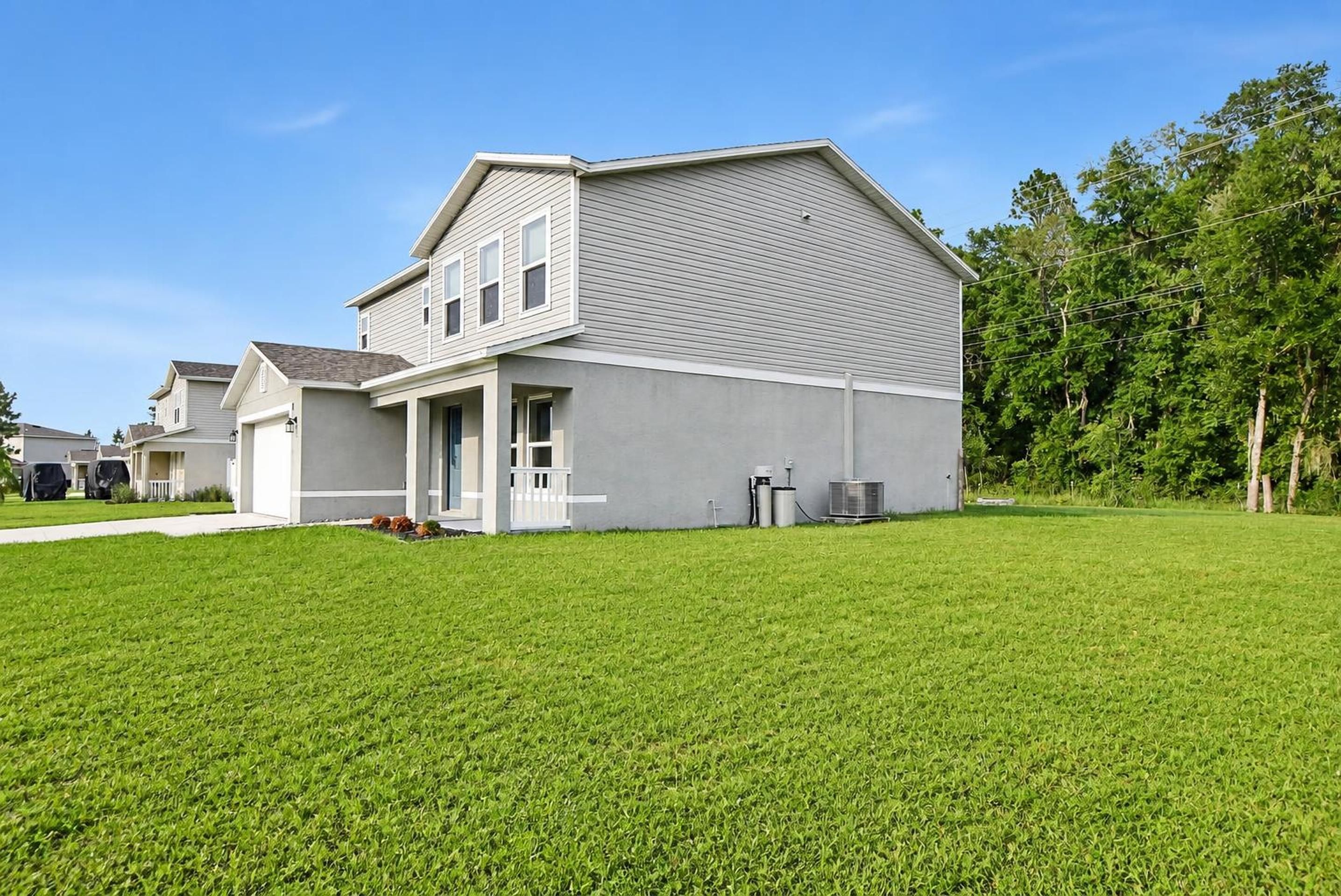 Side yard and exterior of 205 River Hill Drive