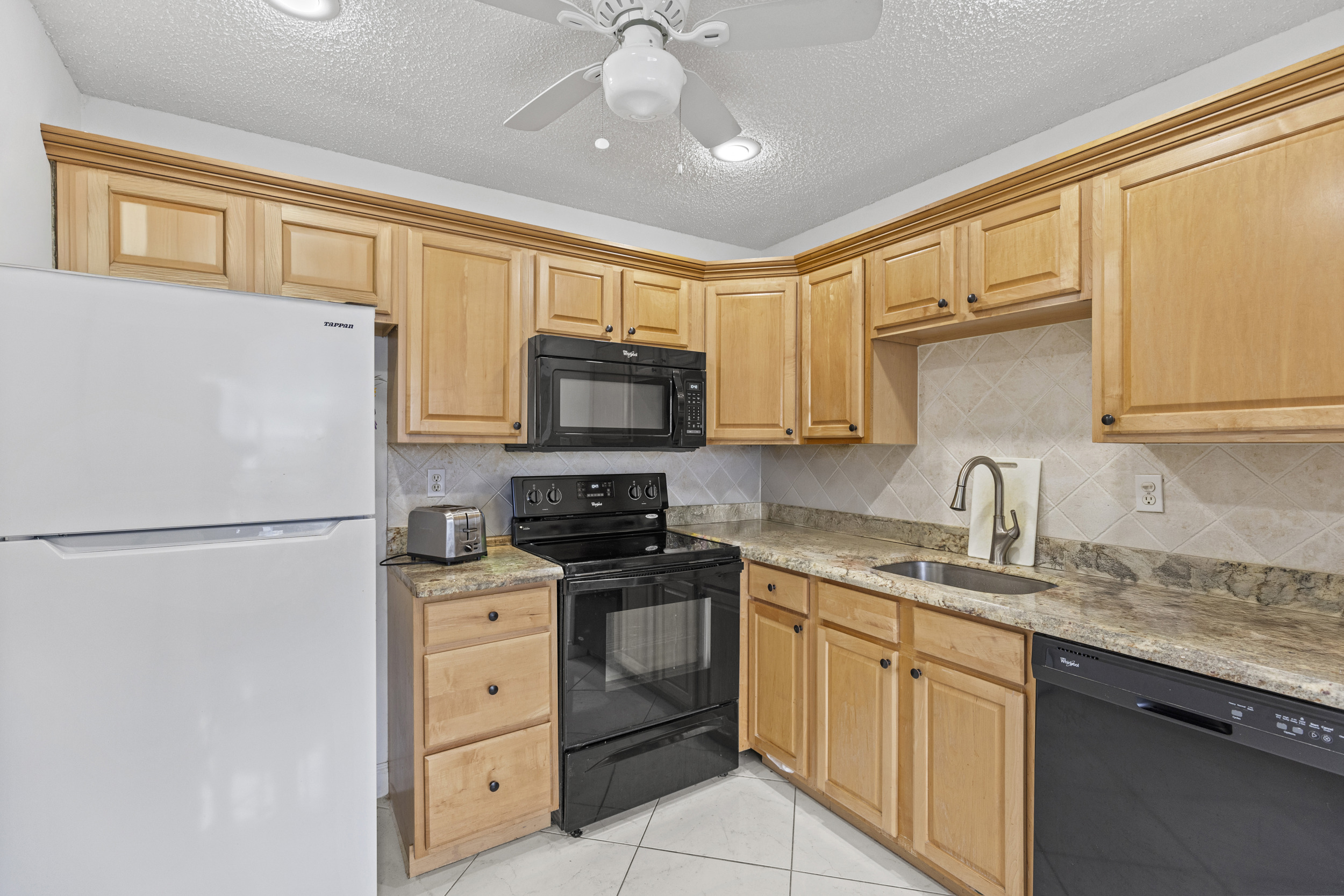 Interior Kings Point condo updated kitchen Delray Beach Florida with modernized appliances and cabinetry