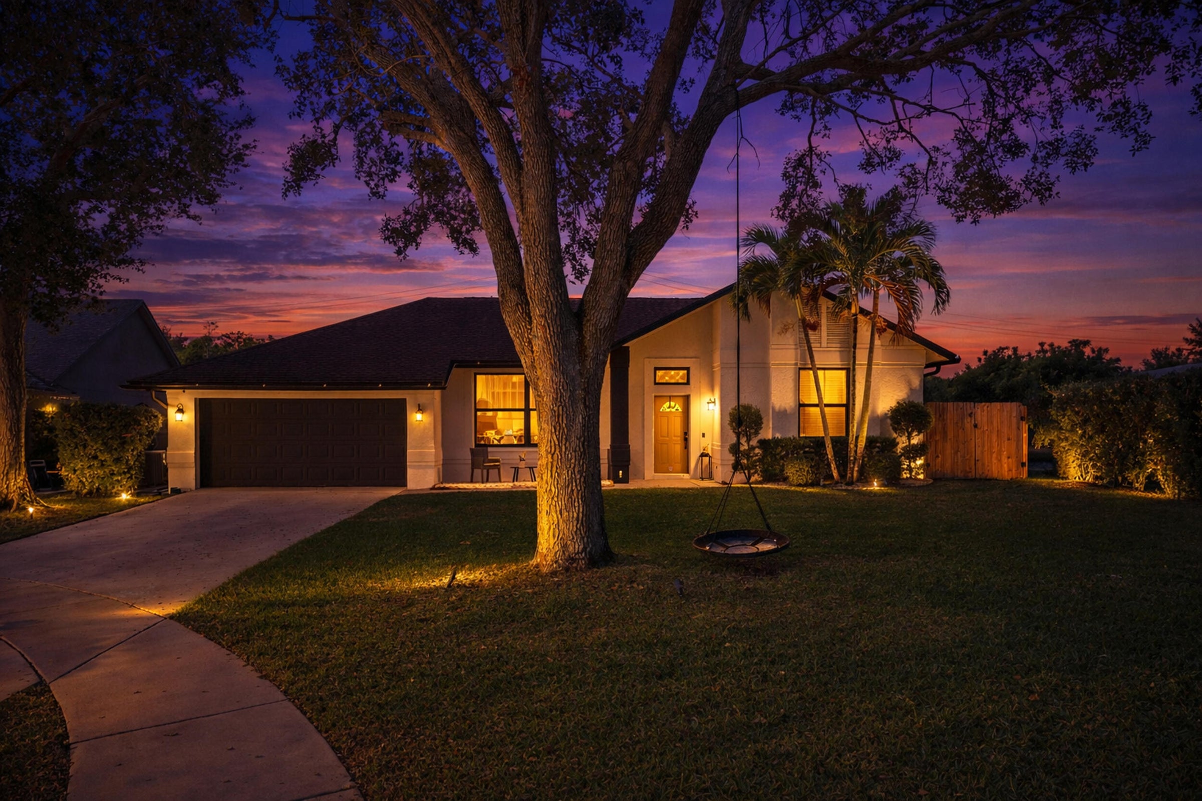 Twilight exterior of Lake Worth Florida home in Woods Walk 2 on a quiet cul-de-sac near the lake