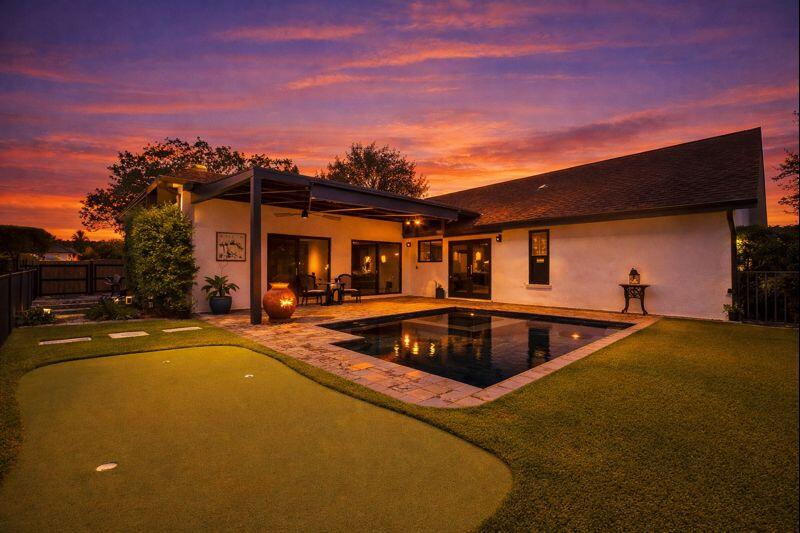 Lakefront pool home in Woods Walk 2 Lake Worth Florida with Arcadia louvered patio system over the pool