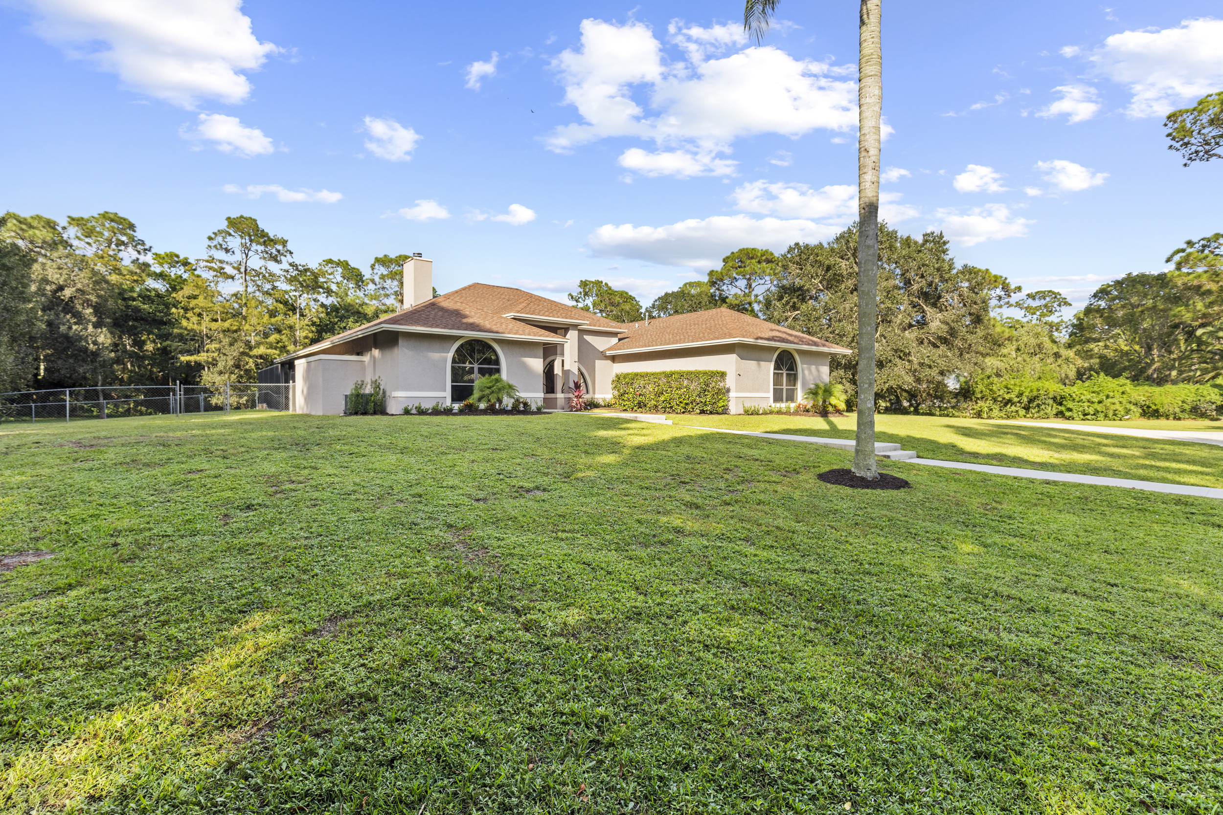 Two acre home in The Acreage Loxahatchee with large front yard and private land