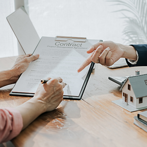 image of client working with real estate agent signing real estate contracts summit county real estate
