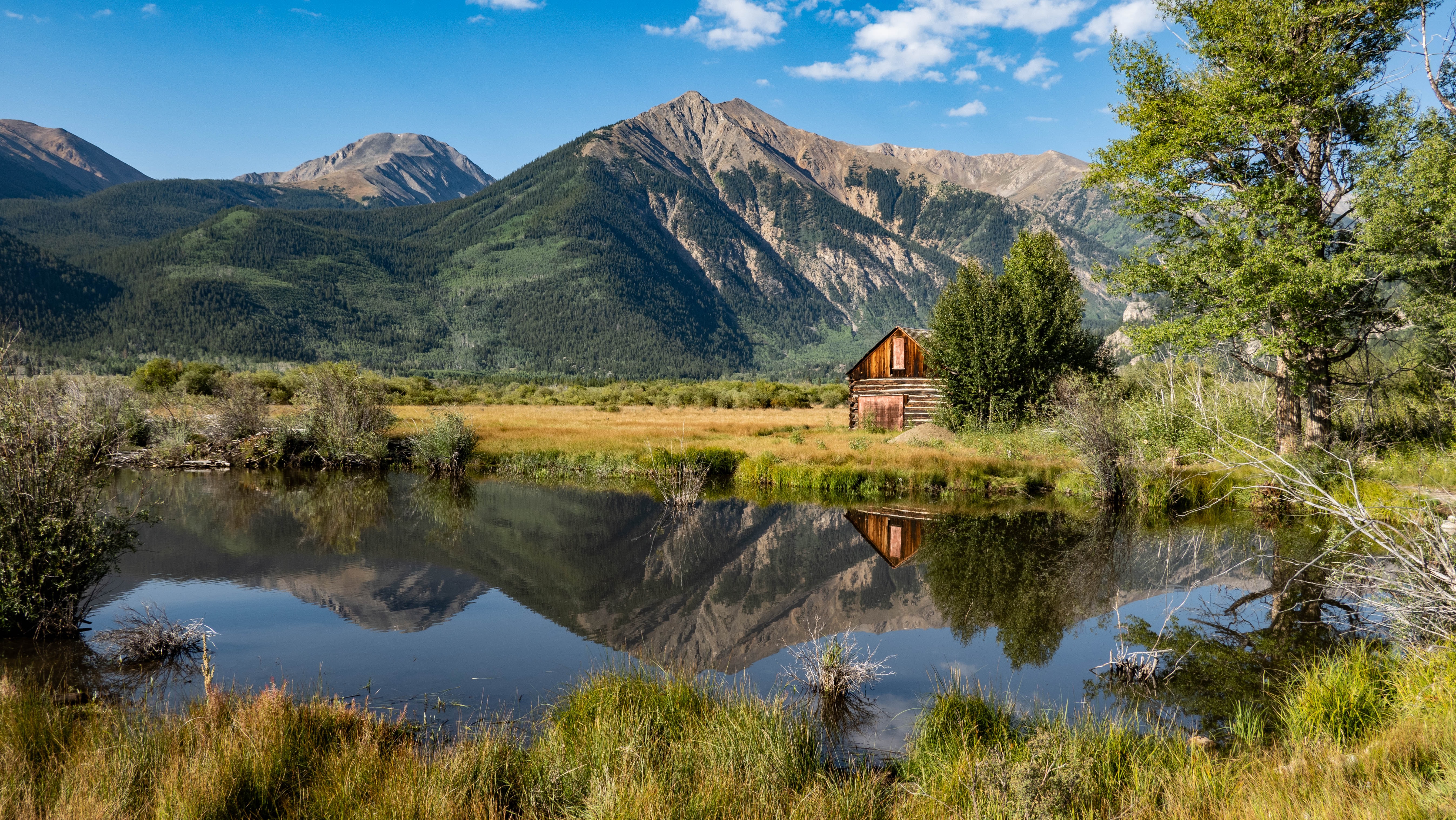Image of vacant land for sale in Colorado overlooking pond and mountain